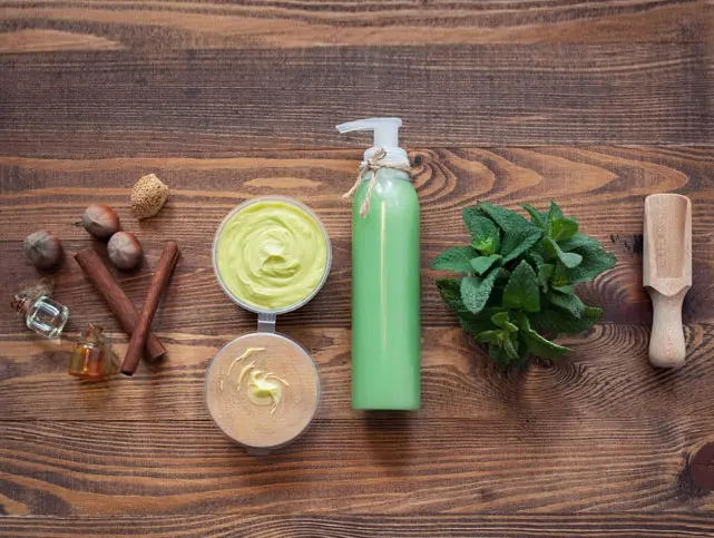 A wooden table with some green products on it